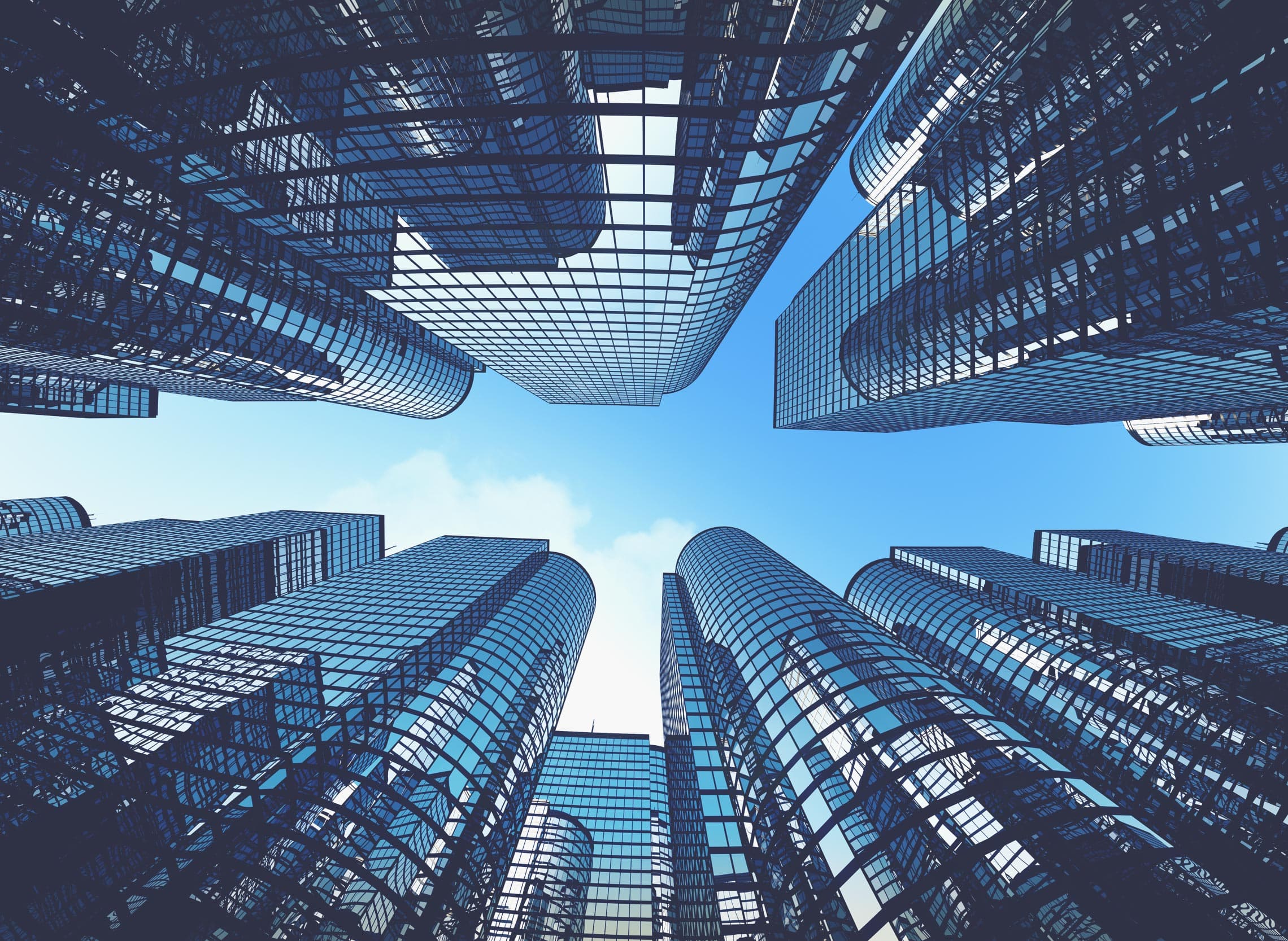 Looking up at glass skyscrapers against a blue sky